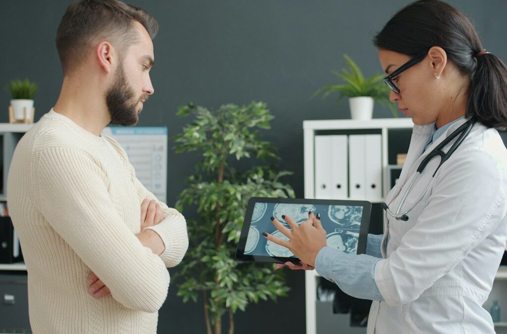 Doctor showing a patient their imaging results on a tablet