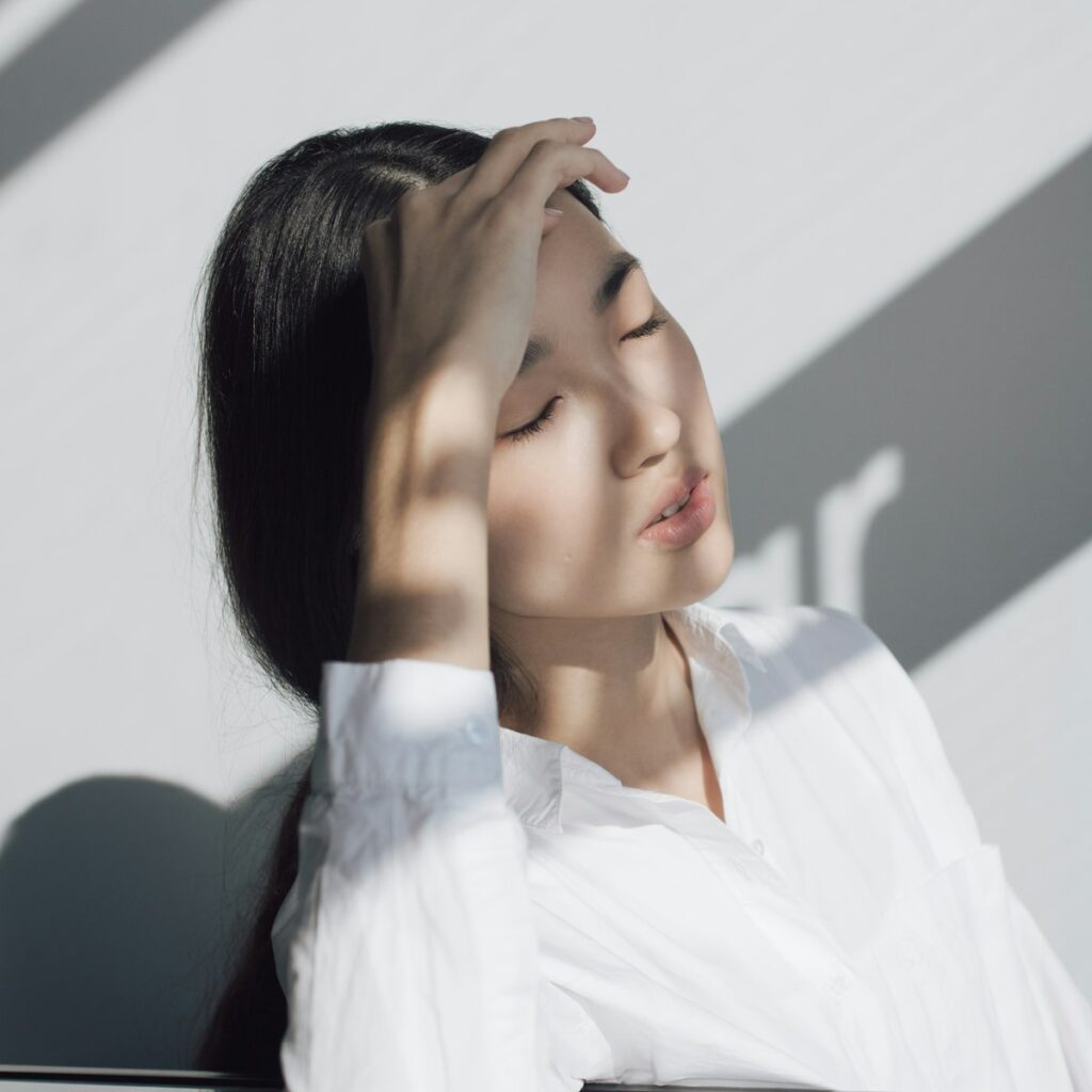 Woman feeling lightheaded from POTS symptoms