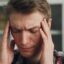 Man holding his temples during a migraine headache